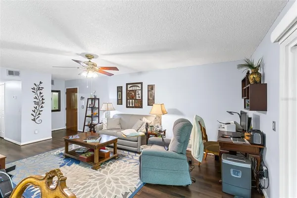 a living room with furniture and wooden floor