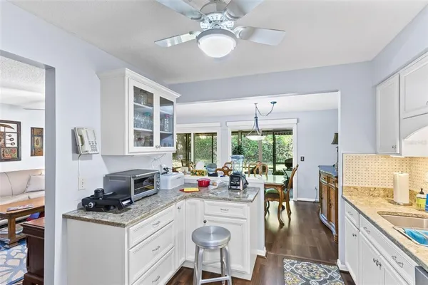 a kitchen with a stove a table and chairs