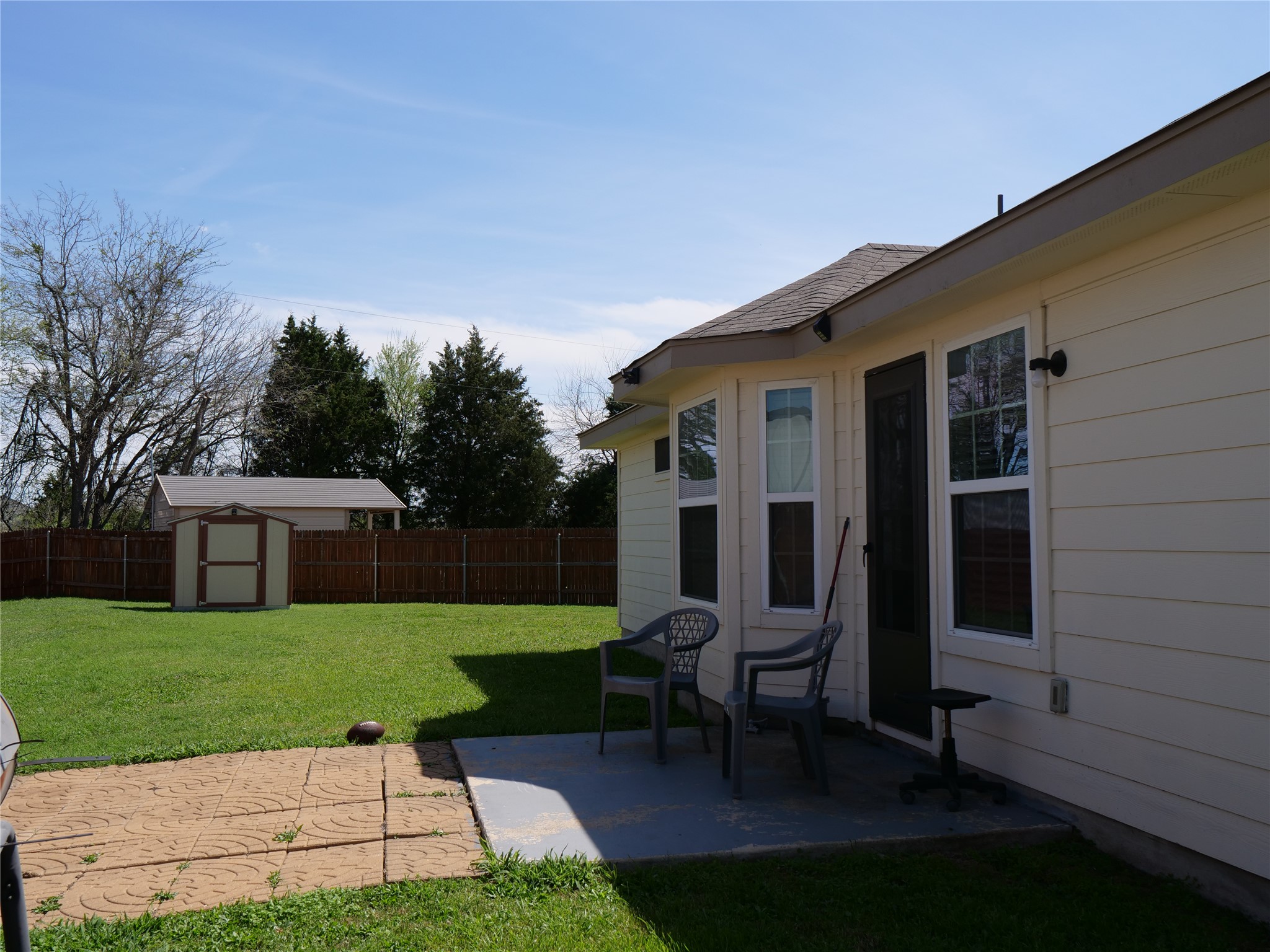 Undisclosed Address Elgin, TX 78621 - Photo 18 of 19 Fenced backyard featuring a storage shed and a patio