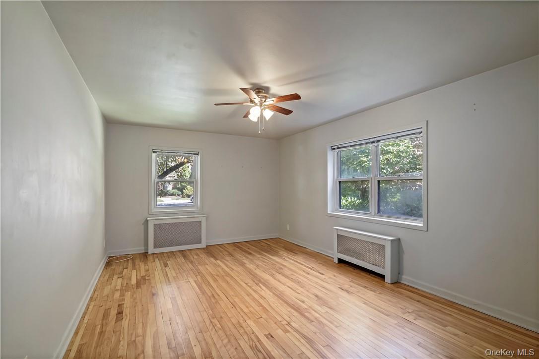 330 South Broadway, Unit H4 Tarrytown, NY 10591 - Photo 6 of 18 Living Room featuring two windows, ceiling fan and hardwood floors