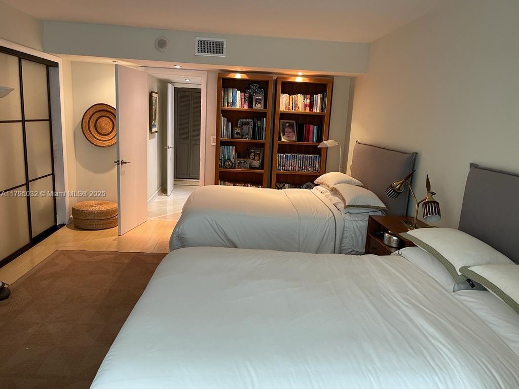 600 Grapetree Drive, Unit 7CS Key Biscayne, FL 33149 - Photo 13 of 19 a bedroom with a bed and walk in closet