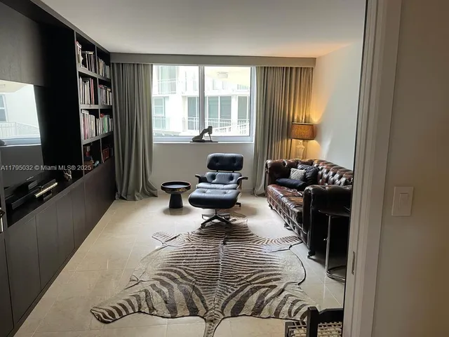 a living room with furniture window and a flat screen tv