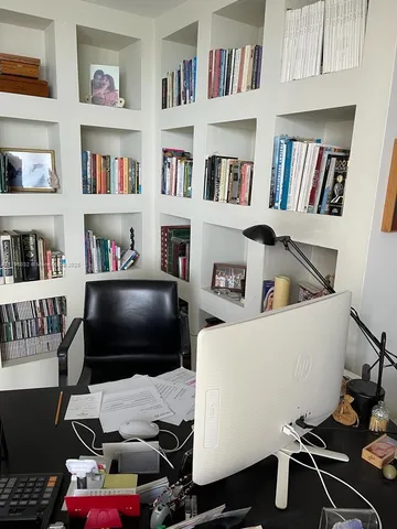 a living room with furniture and a book shelf