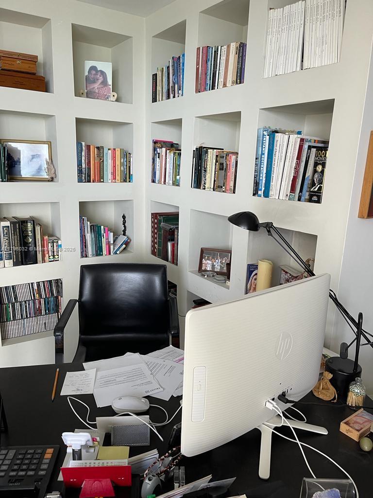 600 Grapetree Drive, Unit 7CS Key Biscayne, FL 33149 - Photo 8 of 19 a living room with furniture and a book shelf