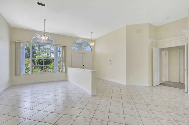 a view of a kitchen with kitchen island a sink stainless steel appliances and cabinets