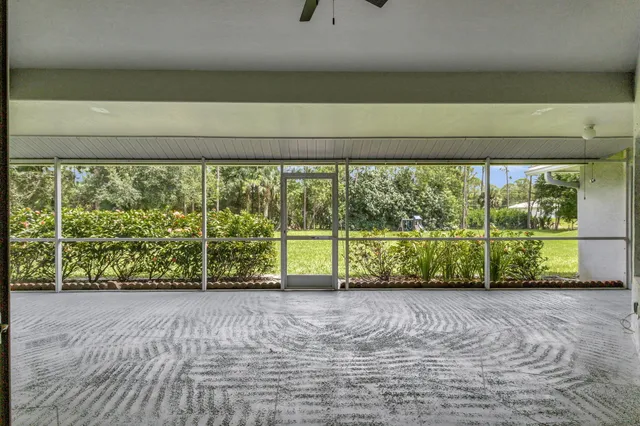 an aerial view of a house with a yard and outdoor seating