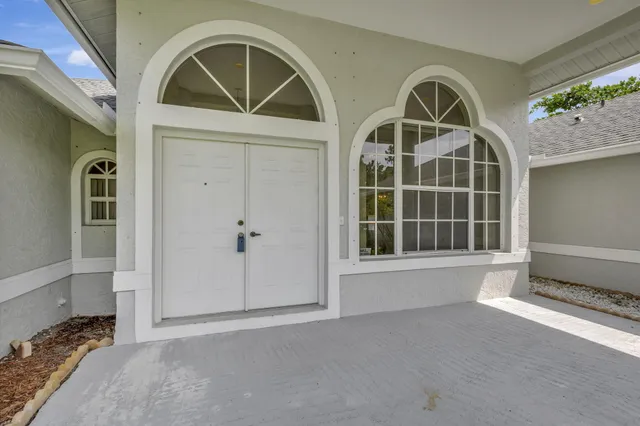 a view of an empty room with glass door and glass door
