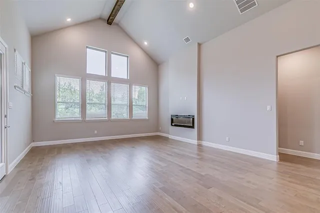 an empty room with windows and closet
