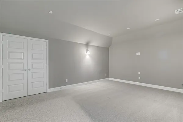 an empty room with windows and closet