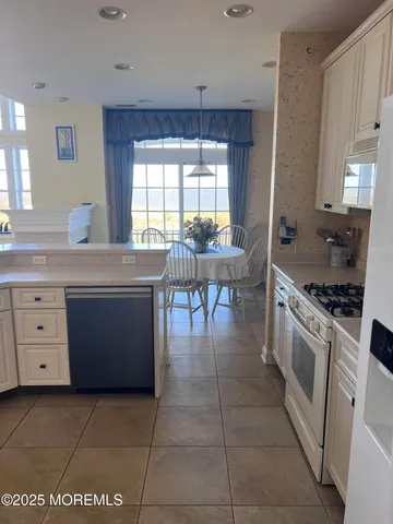 a view of a living room with furniture and a floor to ceiling window