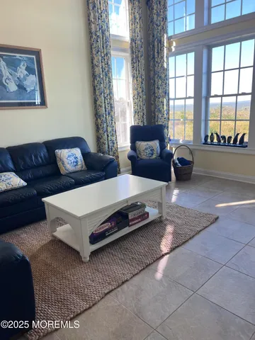 a bedroom with furniture and a flat screen tv
