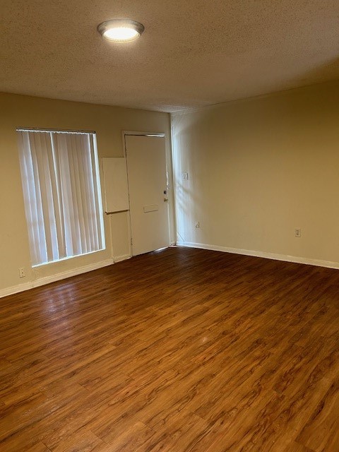 4709 Harmon Avenue, Unit 322 Austin, TX 78751 - Photo 7 of 8 an empty room with wooden floor and windows