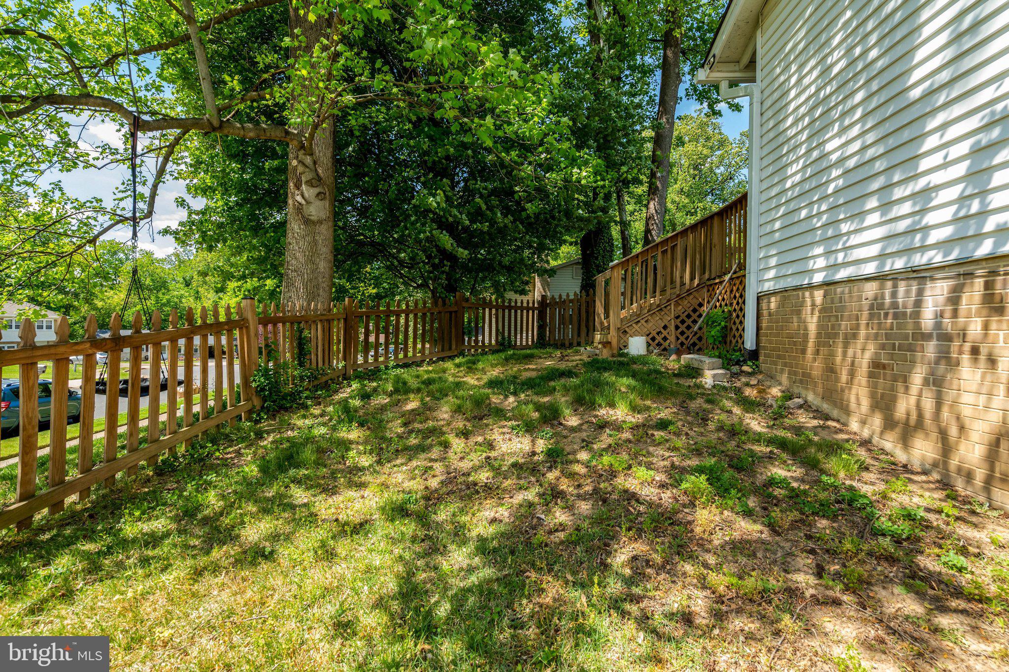 7212 Galgate Drive Springfield, VA 22153 - Photo 35 of 39 a backyard of a house with large trees and plants