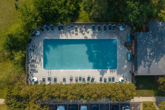 an aerial view of residential houses with outdoor space and lake view