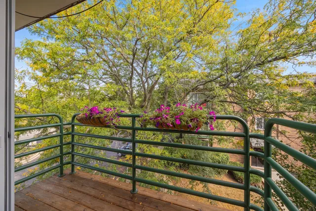 a wooden bench sitting in front of a building