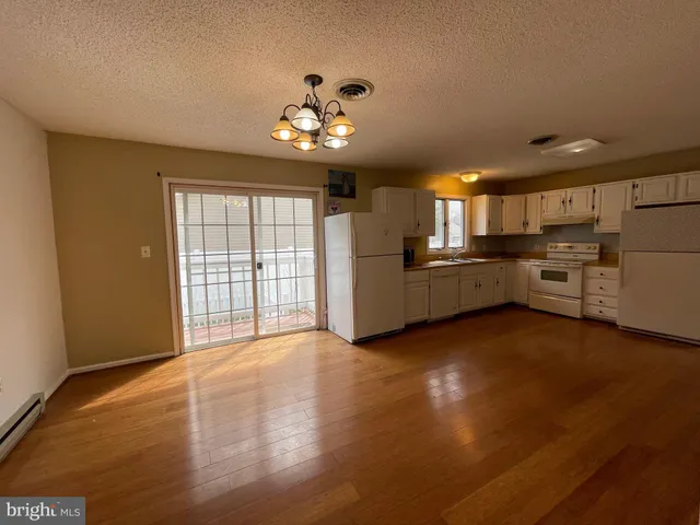 a view of a kitchen with a stove cabinets and a kitchen