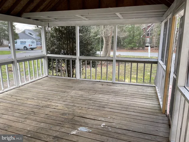 a view of a balcony with wooden floor