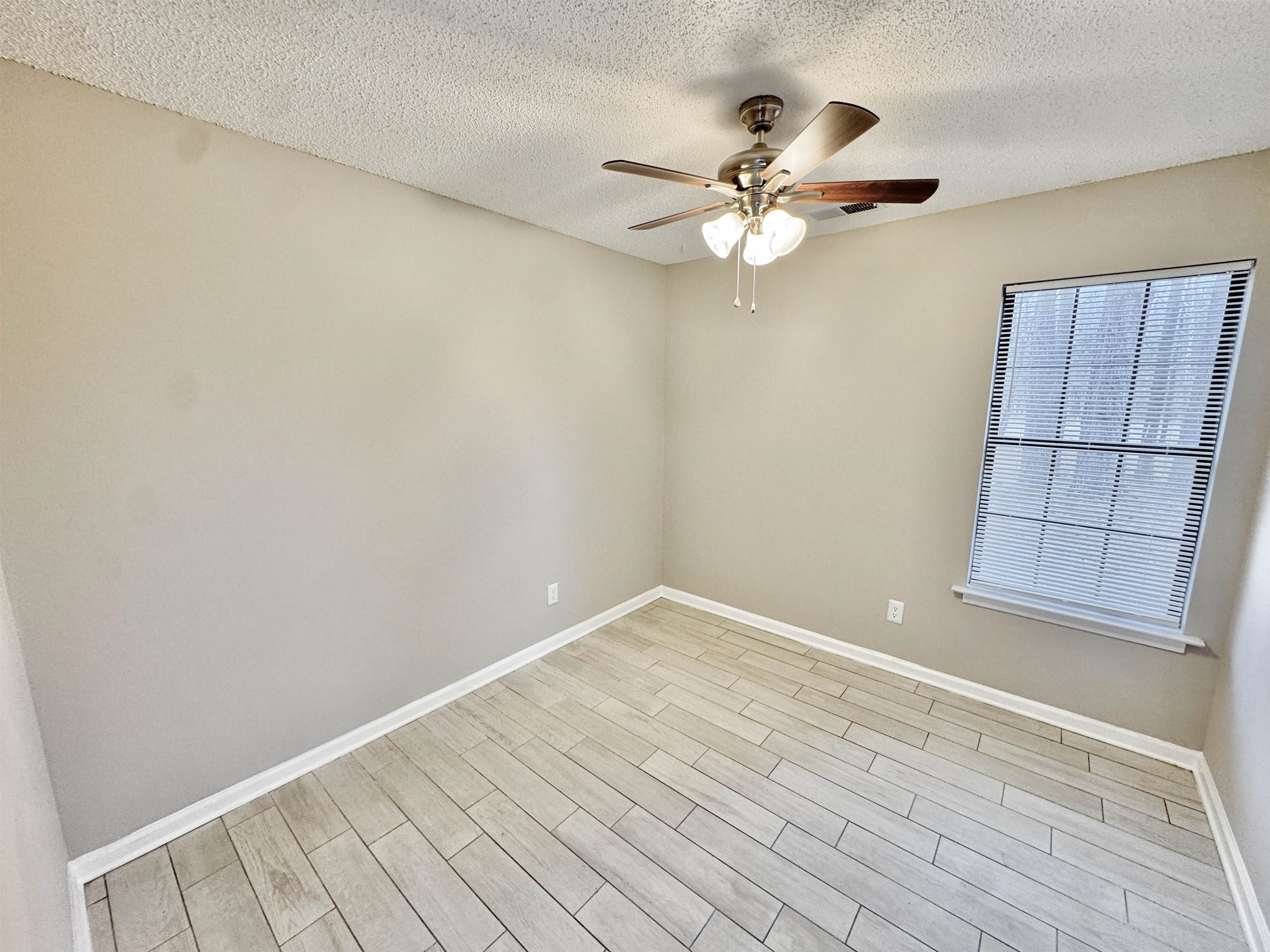 6400 Kerrville Rosemark Road Millington, TN 38053 - Photo 18 of 36 Unfurnished room with wood finish floors, a textured ceiling, and a ceiling fan