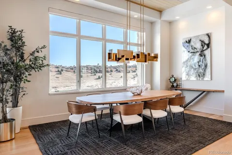 a dining room with furniture a rug and a large window