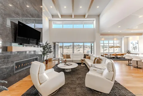 a living room with furniture a flat screen tv and a large window