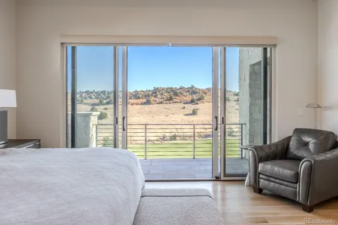 a bedroom with a bed and glass window