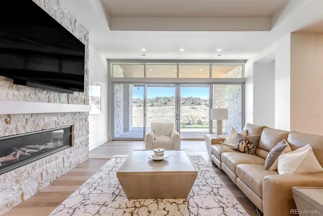 a living room with fireplace furniture and a flat screen tv