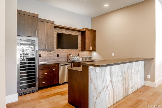 a kitchen with stainless steel appliances kitchen island granite countertop a refrigerator stove and sink