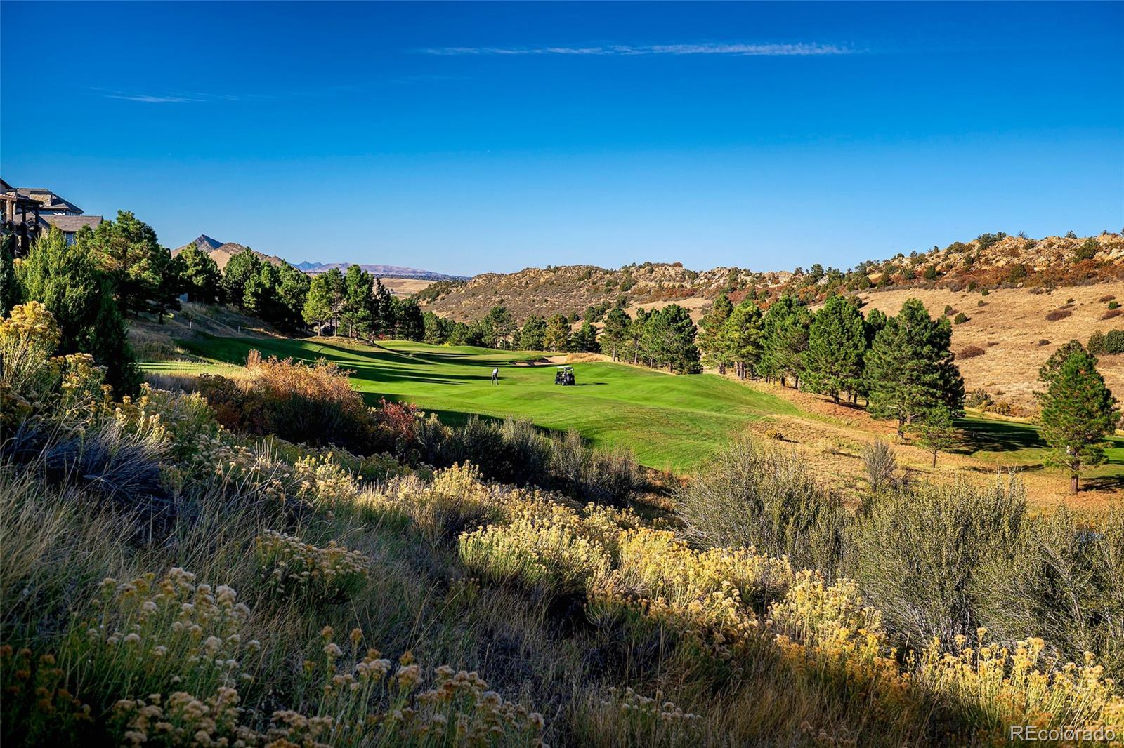 7572 Raphael Lane Littleton, CO 80125 - Photo 47 of 50 a view of a lake with a mountain in the background