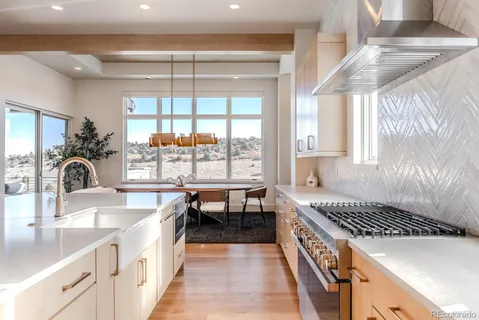 a kitchen with a sink a stove and cabinets