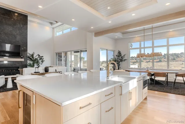 a large kitchen with kitchen island a sink appliances and a counter space