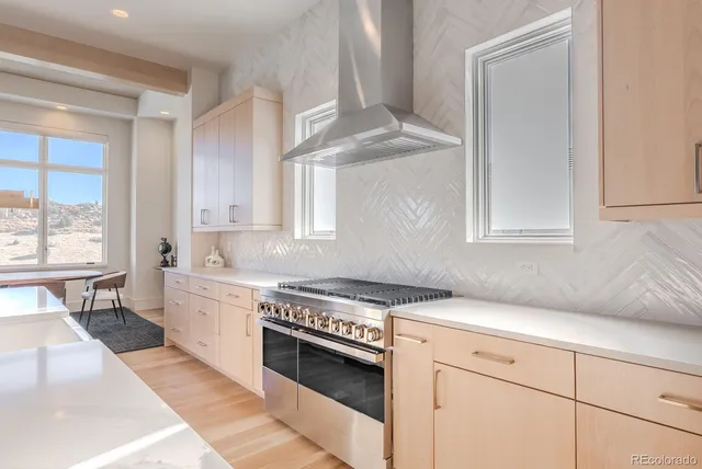 a kitchen with stainless steel appliances granite countertop a sink stove and cabinets