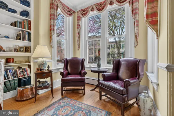 a living room with furniture and a book shelf