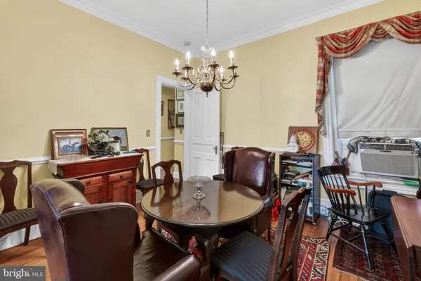 a view of a dining room with furniture and a chandelier