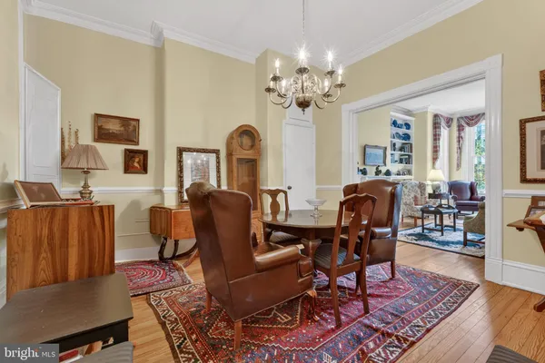 a living room with fireplace furniture and a chandelier