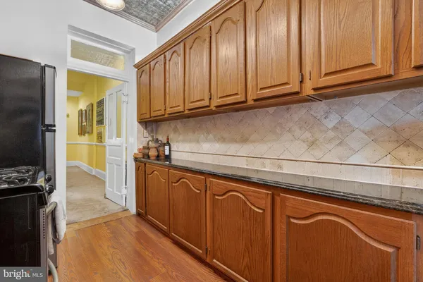 a kitchen with stainless steel appliances granite countertop a refrigerator and cabinets