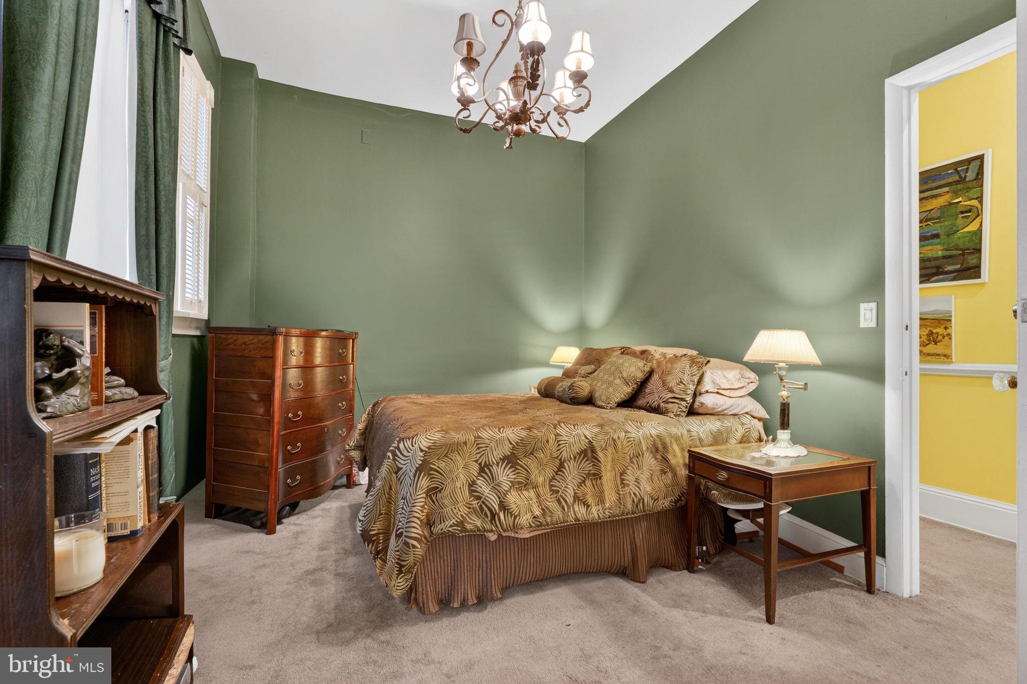 15 3rd Street Northeast, Unit 2 Washington, DC 20002 - Photo 21 of 32 a bedroom with a bed and a chandelier