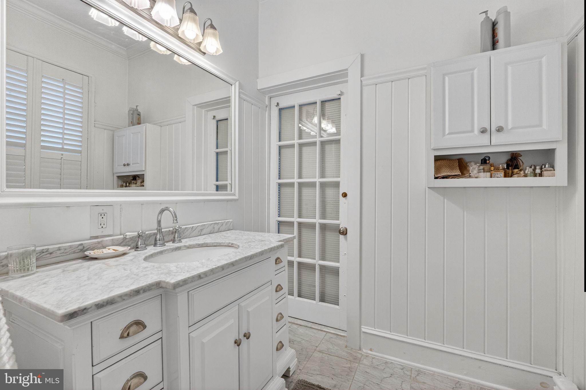 15 3rd Street Northeast, Unit 2 Washington, DC 20002 - Photo 24 of 32 a bathroom with a granite countertop sink and a mirror