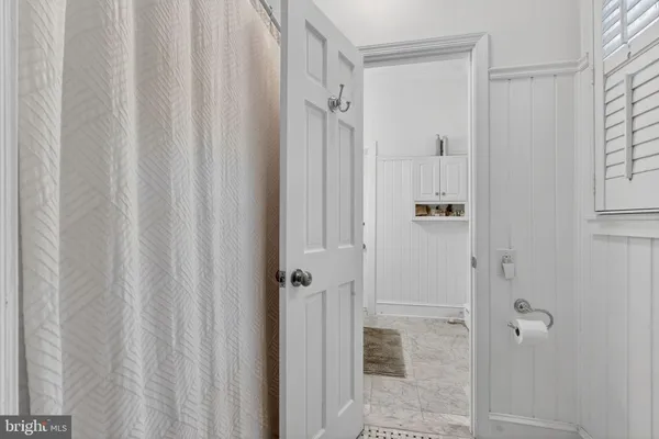 a bathroom with a shower and a glass door