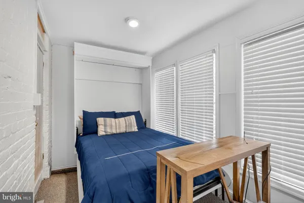 a view of a room with furniture and wooden floor