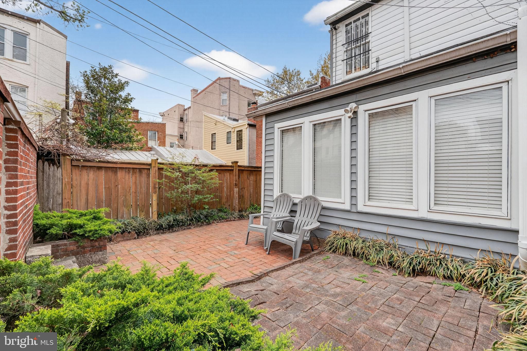 15 3rd Street Northeast, Unit 2 Washington, DC 20002 - Photo 31 of 32 a backyard of a house with outdoor seating and plants