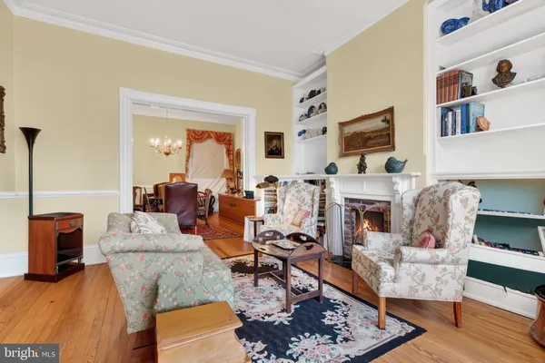 a living room with fireplace furniture and a rug