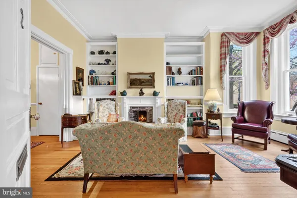 a living room with furniture fireplace and a large window