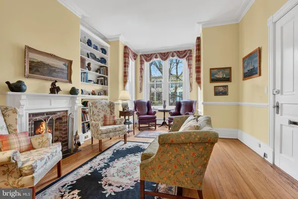 a living room with furniture a fireplace and a large window