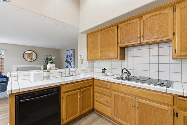 a kitchen with a sink cabinets and a wooden floor