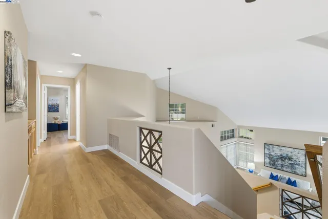 a view of entryway and hall with wooden floor
