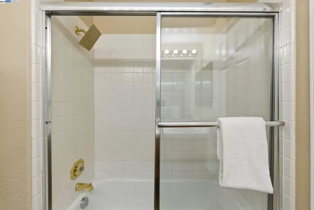 a bathroom with a glass shower door