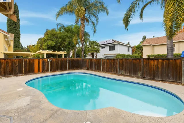 a swimming pool with wooden fence