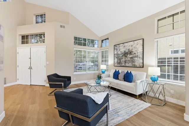 a living room with furniture and a painting on the wall