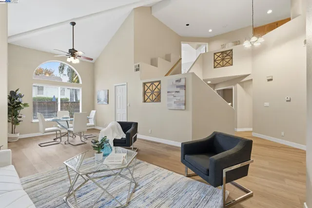 a living room with furniture and a chandelier