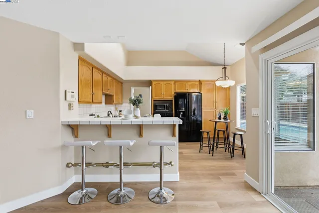a kitchen with stainless steel appliances kitchen island granite countertop a sink and cabinets